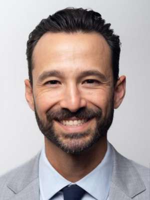 headshot of Kyle Kinder in grey suit