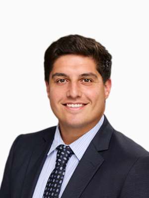 Headshot of unknown person smiling in suit and tie
