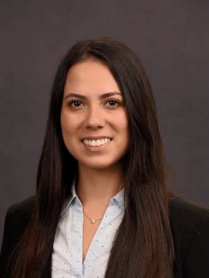 Head shot of Karen Kikuta, MD in business attire, smiling at camera