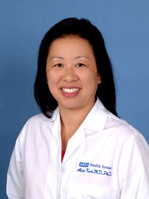 Alice A. Kuo, MD smiling headshot in white coat
