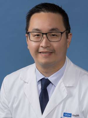Headshot of Eric Y. Lee, DPM, wearing a white coat and a tie.