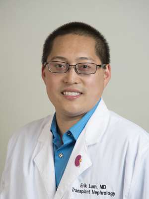 Person in white coat and glasses, professional headshot