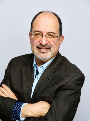 Professional photo of Dr. Arash Naeim wearing a suit and tie
