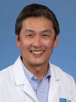 Steven Tan, MD in white coat against blue background