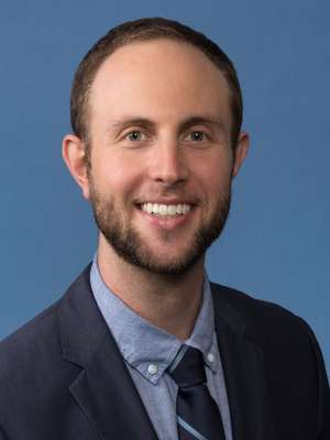 headshot of Marc J. Weintraub, PhD in an indoor setting in front of a blue background