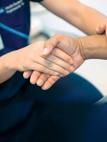Hand of a patient and physician