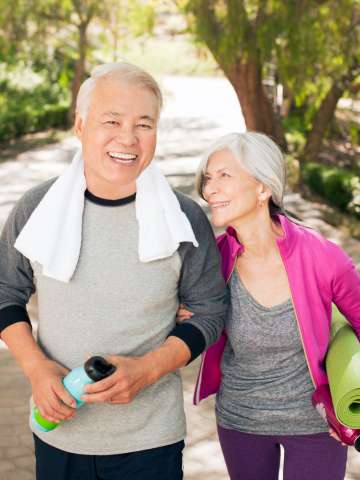 Older couple walking together outdoors