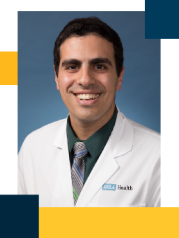 Smiling male doctor in white coat and tie on blue background