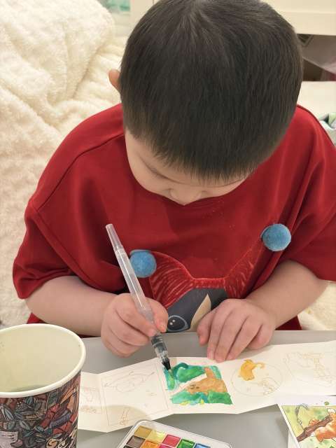 A child creates artwork.