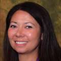 headshot of Dr. Resa Oshiro in front of brown backdrop