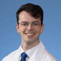 A headshot of John Miggins, MD