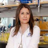 Dr. Sanaz Memarzadeh sitting in a desk chair in the Lab.
