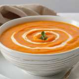    Creamy Carrot-Sweet Potato Soup in white bowl