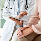 Clinic, tablet and hands of doctor with patient for consulting, medical service and help in hospital.