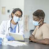Female doctor and female patient discuss treatments