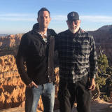 Dr. Justin McWilliams with his father, Dr. Thomas McWilliams pose for a photo outdoors..