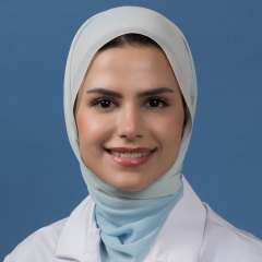 Head shot of Mahdieh Hosseini in white lab coat, smiling at camera