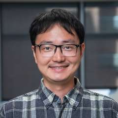 Headshot of Doctor Jijun Huang in a flannel shirt