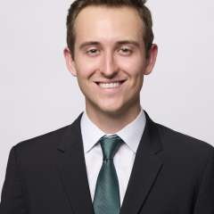 Dr. Brendan Colgan in a suit smiling at the camera