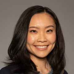 Head shot of Kristine Khieu in business attire, smiling at camera