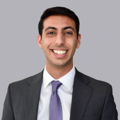 Jonathan Massachi, MD wearing a gray suit jacket, white shirt, grey tie