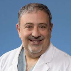 A headshot of Morris Salem, MD in a lab coat in front of a blue background