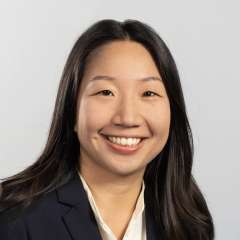 Head shot of Jessica Lam, MD, PhD in business attire, smiling at camera