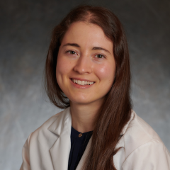 professional headshot of Kristin Boulier, MD in a white lab coat, in front of a gray background