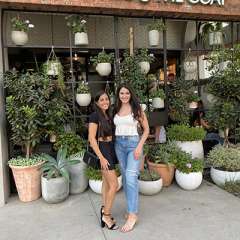 Dr. Hammi and her friend, Christine in front of a plant shop.