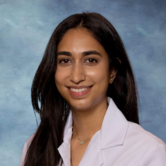 Dr. Sonali Nayak smiling and wearing her UCLA Health white lab coat.