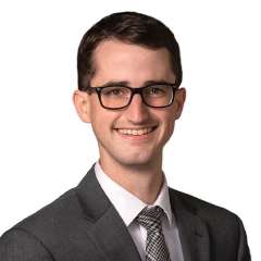 headshot of Dr. Michael Raddatz in gray suit