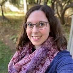 headshot of Kelsey Jarrett in a purple scarf and blue shirt