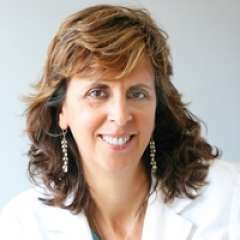 Cheryl Hoffman smiling portrait wearing a white coat