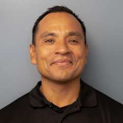 Phot of Julian in a black polo