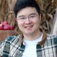 Headshot of Xianghang wearing glasses and a green flannel shirt in the outdoors.