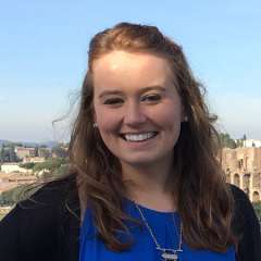 Layna Elder outside with a cityscape in the background