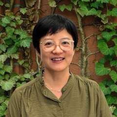 Headshot of Jieping Yang wearing glasses and a green blouse