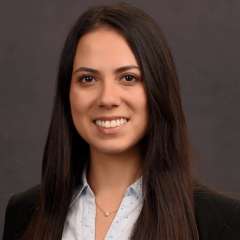 Head shot of Karen Kikuta, MD in business attire, smiling at camera