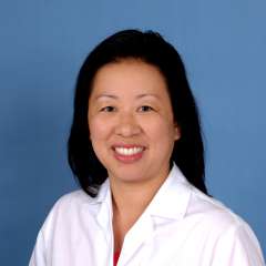 Alice A. Kuo, MD smiling headshot in white coat